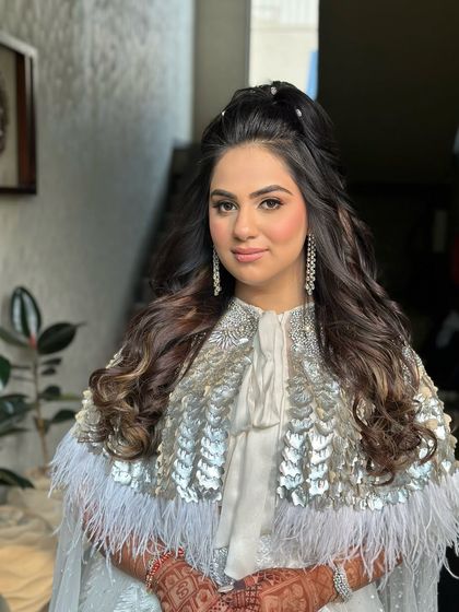 A carnival-ready look with a high half-ponytail and soft waves.