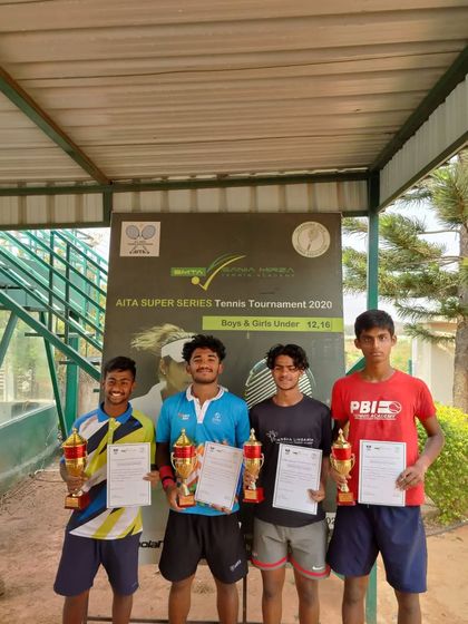 Our player Naishik Reddy with fellow competitors after the AITA Super Series Tennis Tournament, showcasing his trophy.