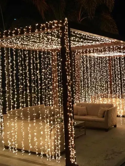 Nothing says magic like a curtain of fairy lights. I use them to transform the pergola into a glowing, elegant sanctuary, creating the perfect, dreamy ambiance for any evening event.