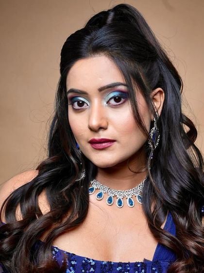 A powerful pose that exudes confidence, enhanced by the striking makeup.