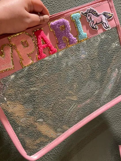 A different style of our personalised pouches, this one features a clear window and fuzzy varsity-style letters for the name 'Pari'.