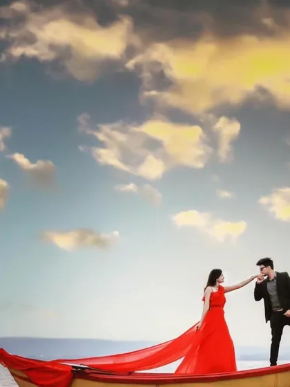 A closer look at the iconic boat scene. The vibrant red of the gown stands out beautifully against the water and sky, showcasing how the right outfit can elevate your pre-wedding photography.