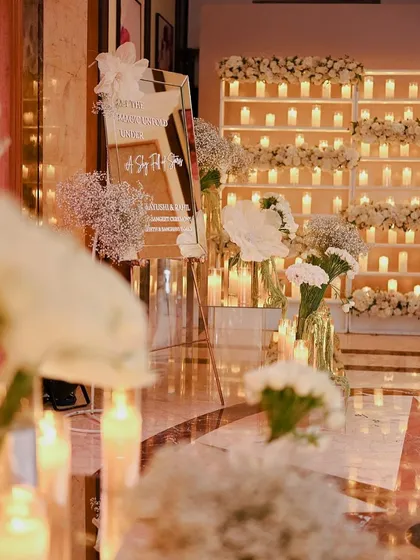 The welcome area, where a mirrored sign and candle walls set a glamorous tone for the evening.