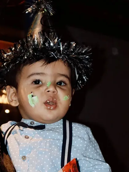 A candid shot from my nephew's first birthday party, with cake on his face and a party hat on. Capturing these real, unposed moments is what makes event photography so special.