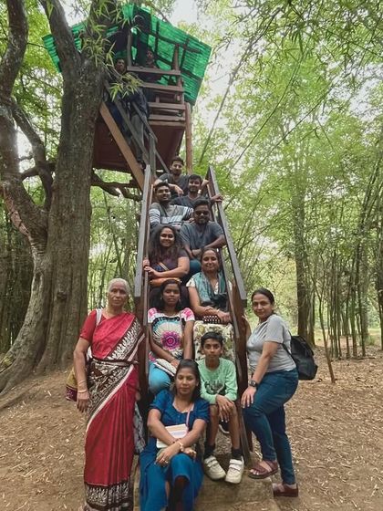 The group posing on a treehouse platform in a bamboo forest in Coorg.