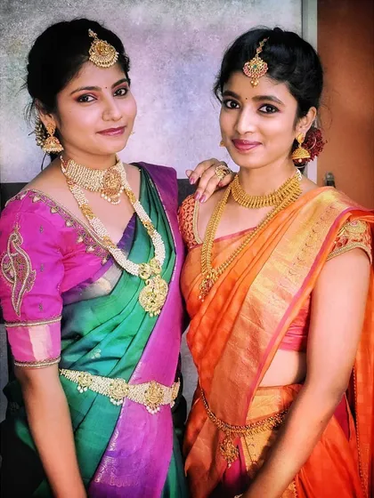 I love working with the entire bridal party. Here are two sisters styled for a wedding, showcasing how I can create complementary yet individual looks, one with pearl jewellery and the other with classic temple gold.