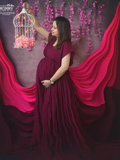 Lighting up the path for her little one. Using props like this lighted birdcage, we can add a touch of whimsy and meaning to your glamorous studio maternity session.