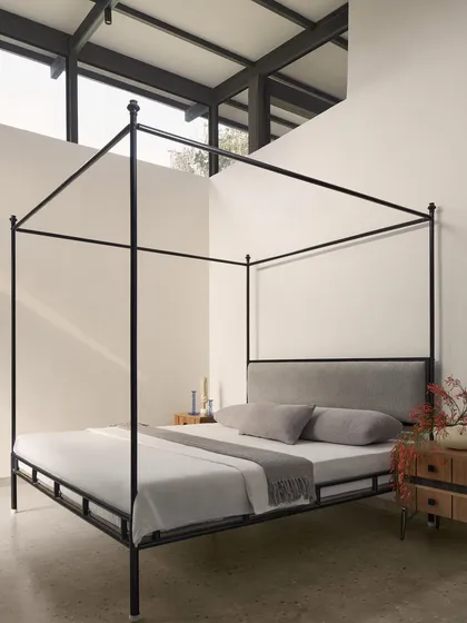 In the Pavilion House, we designed this bedroom to be a minimalist escape. The simple elegance of the four-poster bed is set against a double-height window, blurring the line between the interior and the serene landscape outside, creating a space of profound tranquility.