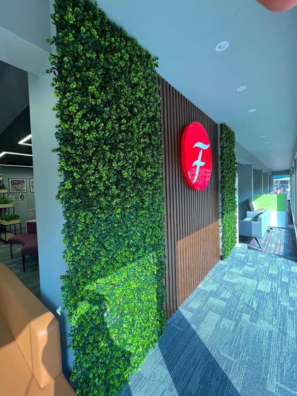 A beautiful corridor at the Featherlite office, featuring our artificial green walls. This installation transforms a simple hallway into a vibrant and engaging part of the office environment.