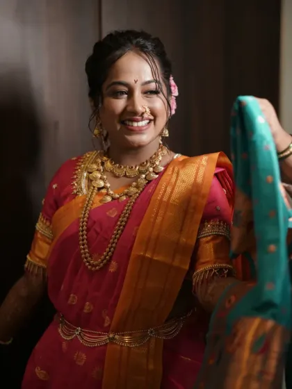 A candid moment of the bride getting ready, her joy evident as she prepares for her big day.
