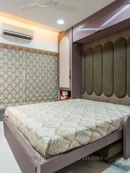 Here is the magic. The sofa is removed, and the wall unit folds down to reveal a full-sized, comfortable bed with a plush, upholstered headboard. This is how we create a bedroom that appears out of nowhere.
