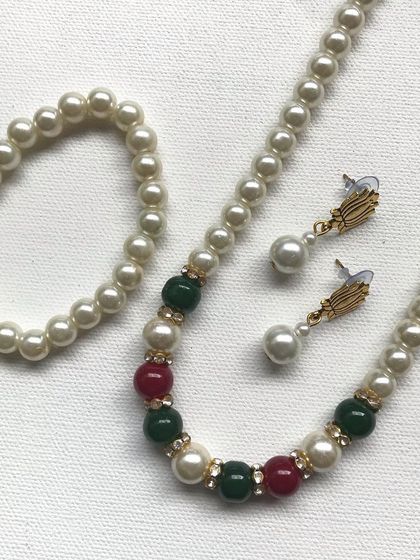 A slightly different view of the pearl necklace set, highlighting the arrangement of the colourful beads. This is a popular item for festive gifting.