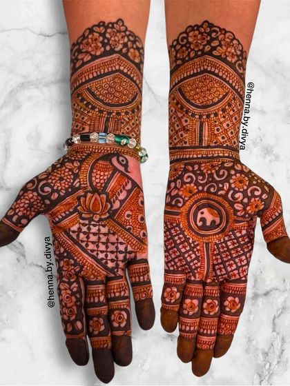 A rich design combining peacock and elephant motifs. The central elephant is surrounded by intricate floral patterns, while the other hand features a peacock.