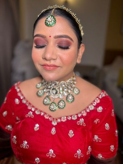 A final look at the bride with her eyes closed, showcasing the beautiful eyeshadow work. The colors perfectly complement her traditional outfit.