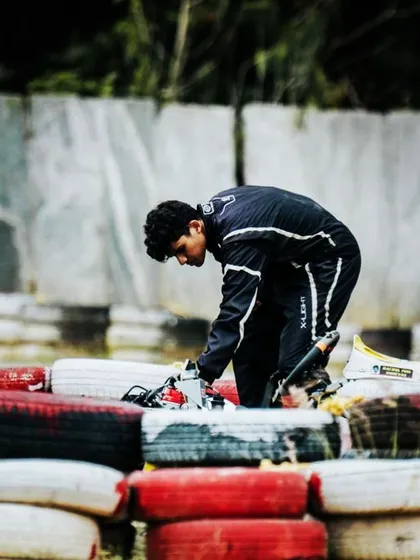A driver inspects his kart after a crash.