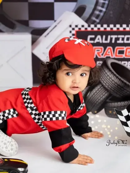 On your marks, get set, crawl! This action shot perfectly captures the playful spirit of a one-year-old in our exciting race car setup.