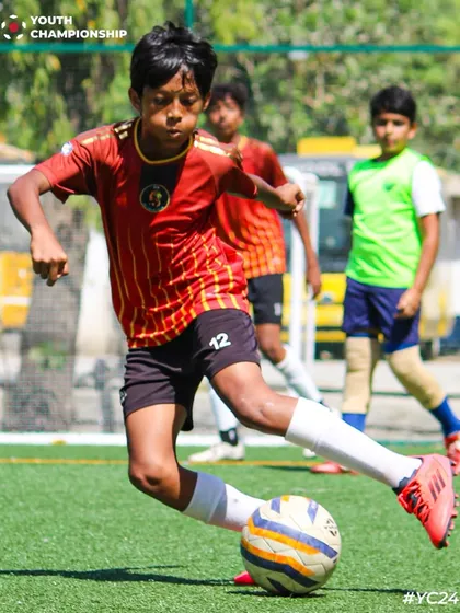 A young player about to strike the ball, showing great technique and focus.