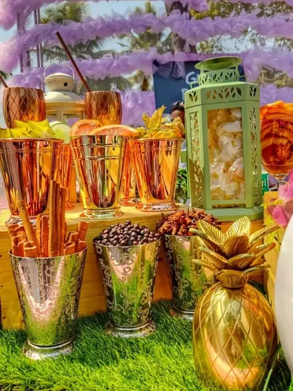 A close-up of the elegant copper and silver goblets used at my gin bar. They are filled with fresh garnishes like grapefruit slices and herbs, ready for guests to create their bespoke gin and tonic cocktails.