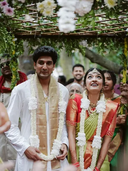 The couple under the floral canopy after the bride's entry. The chadar was designed to be light and airy, complementing the garden theme.