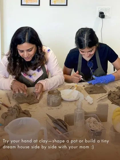 Two participants fully engaged in a clay handbuilding session. Our workshops are perfect for trying something new with a friend or partner.