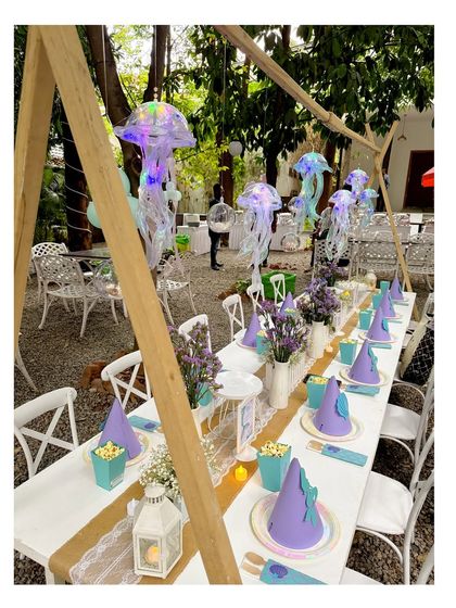 Another view of the magical mermaid dining experience, with glowing jellyfish hanging above the table.