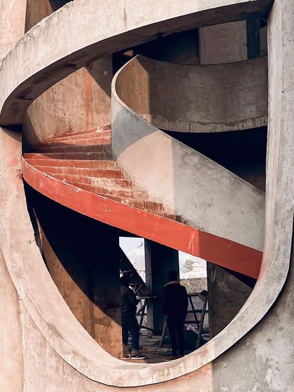 A view through one of the organic openings in the facade, showing the interplay of curves and the raw beauty of the construction process.