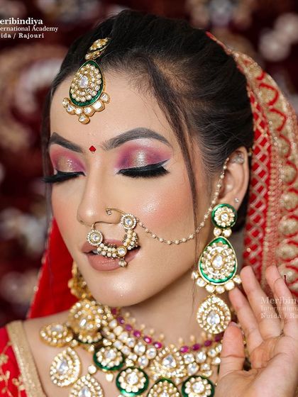 This is a quintessential Indian bridal look. The focus is on bold pink and gold eye makeup and perfectly defined features that radiate elegance.