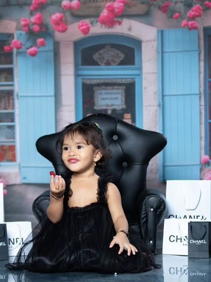 A playful moment from our Paris shopping trip, with the little girl sitting in a miniature armchair.