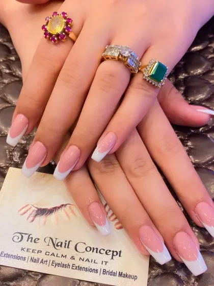 A beautiful, classic French manicure on long, square-shaped nails. The sheer pink base and bright white tips create a sophisticated and glamorous look.