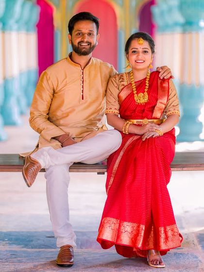 A happy portrait of a couple on a swing in our colorful Jaipuri palace set.