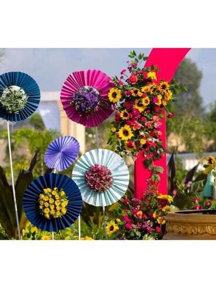 A close-up of the handmade paper fan decorations, adding a pop of color and a playful touch to the event.
