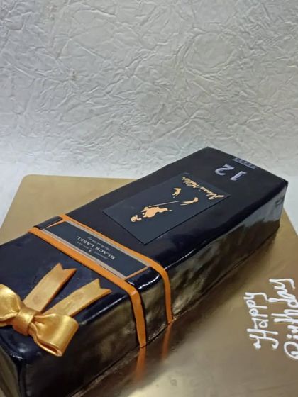 A sleek and realistic Johnny Walker Black Label box cake. This sculpted cake is a sophisticated choice for a whisky aficionado's birthday.