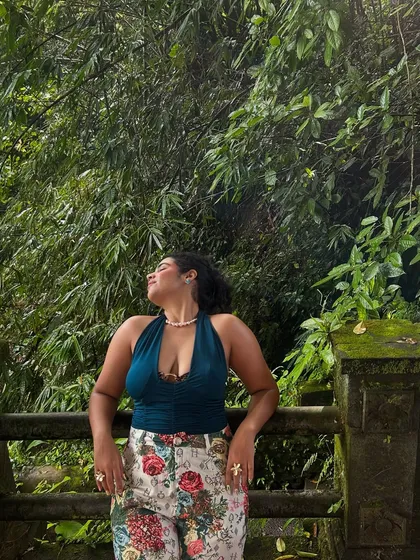 Soaking up the sun in the Ubud jungle. The lush green background makes the colors of my floral pants and teal top pop even more.
