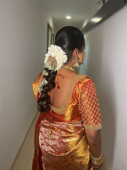 A beautiful messy braid adorned with fresh flowers, perfect for a Muhurtham look that is both traditional and modern.