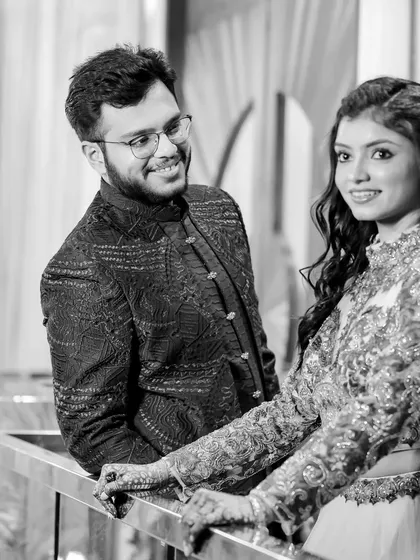 A timeless black and white portrait. The groom's loving gaze and the bride's elegant pose make this a classic and beautiful engagement photo.