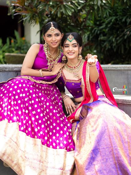 A fun and interactive shot of the two models, capturing a moment of connection and friendship.