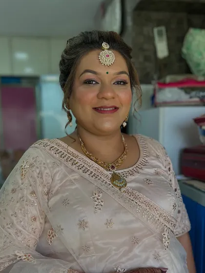 A smiling portrait showing her complete look. She looks graceful and ready for the wedding ceremony.