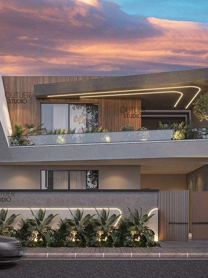 A closer look at the home with the curved facade, this angle shows how the cantilevered balcony creates a sheltered outdoor space. The integrated lighting within the structure emphasizes its unique form, especially at dusk.