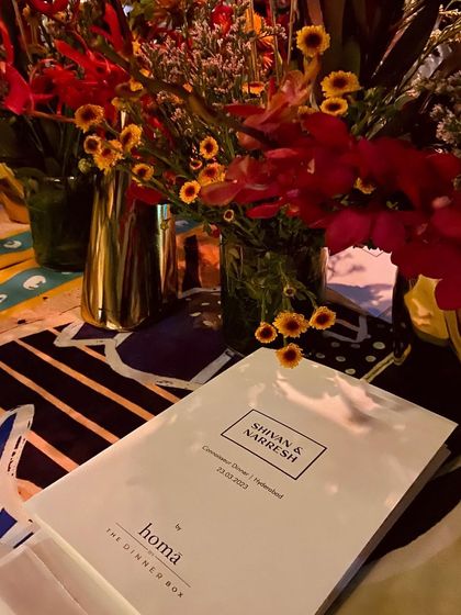 A close-up of the custom menu we designed for the Shivan & Narresh event, resting on their iconic printed table linen.