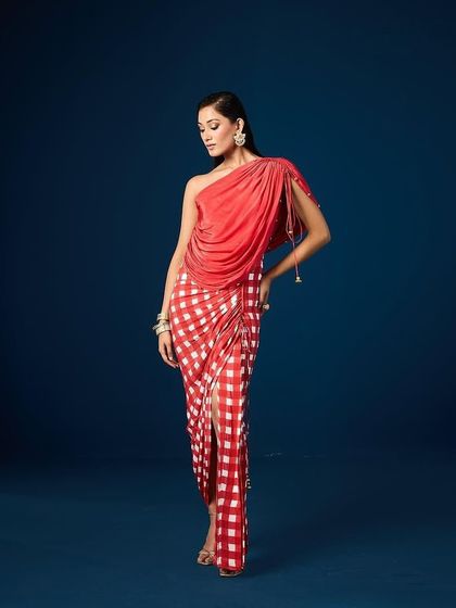 An elegant draped dress from Aapro, shot against a custom-painted deep blue backdrop. This demonstrates our use of paintable sets to create a specific mood that complements the collection's aesthetic.