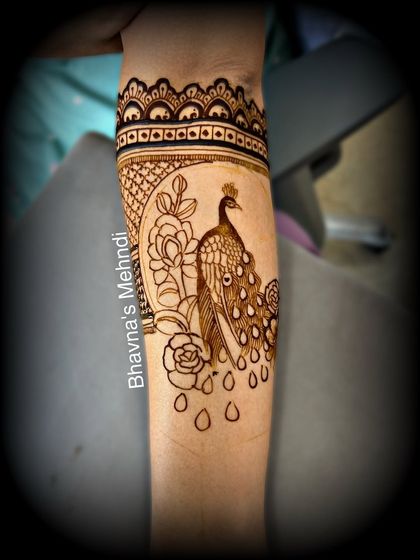 A practice design of a peacock on an arm, showing how we translate our sketches into real applications.