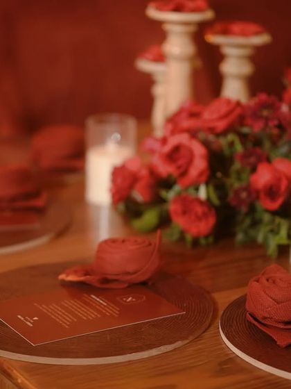 A view of the table setting, showing the warm and inviting ambiance created by the layers of red.