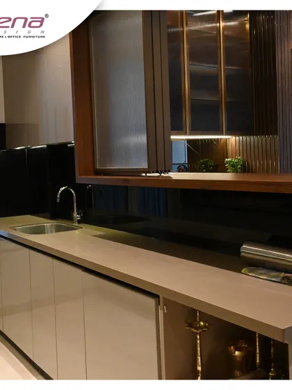 A closer look at the details of a neutral-toned kitchen. The combination of a light countertop, handle-less cabinets, and a dark, reflective backsplash creates a balanced and sophisticated look. I also integrated a bar and crockery unit for added functionality.