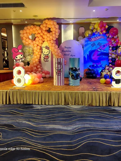 A wide view of the joint Hello Kitty and Hot Wheels birthday stage. This shows how I can combine two different themes on one stage for a shared party.