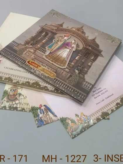 A stunning invitation with a 3D depiction of a royal couple in a temple setting. The intricate details and matching inserts make this a standout piece for your wedding.