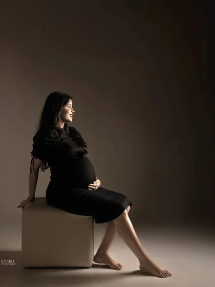 A quiet moment of reflection for the mama-to-be. We use dramatic lighting in our studio to create these powerful, fine art maternity portraits that feel both timeless and deeply personal.