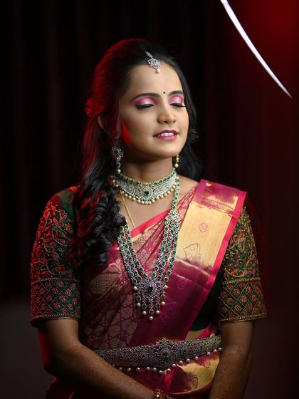 A full shot of Disha's reception look, showing how the makeup complements her rich pink and green saree.