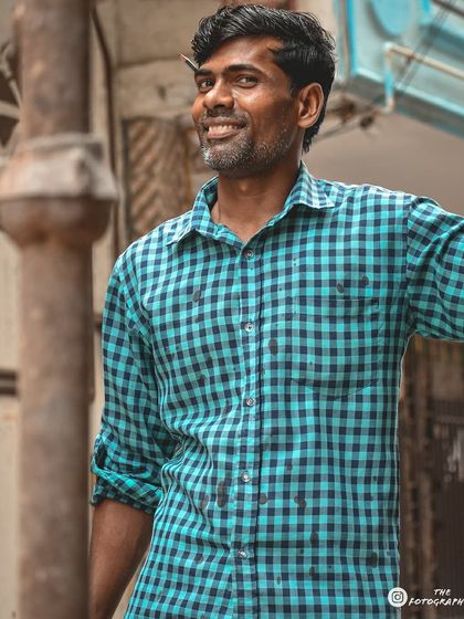 A candid moment of a man smiling, captured on a city street. The natural pose and genuine expression are what I look for in my documentary-style portraits.