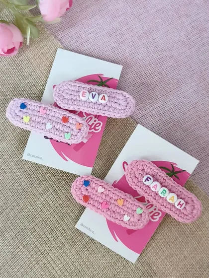 Pretty in pink! This pair of custom name clips for 'Eva' and 'Farah' shows our solid pink crochet base, decorated with tiny colorful heart beads for an extra touch of fun.