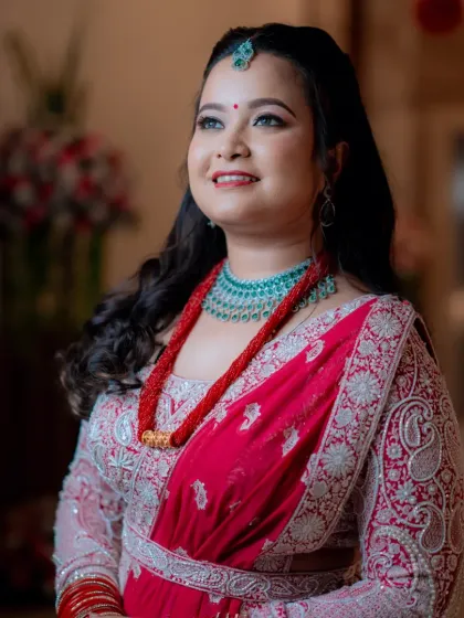 A portrait of the bride, showcasing her traditional Tilhari necklace and soft, loose curls.